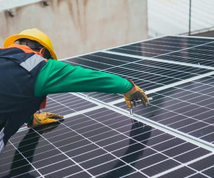 Solar technician installing solar panel